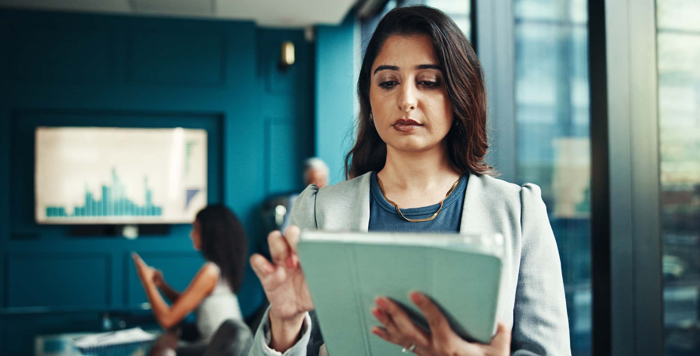 Business woman in an office working doing research and analysis. 