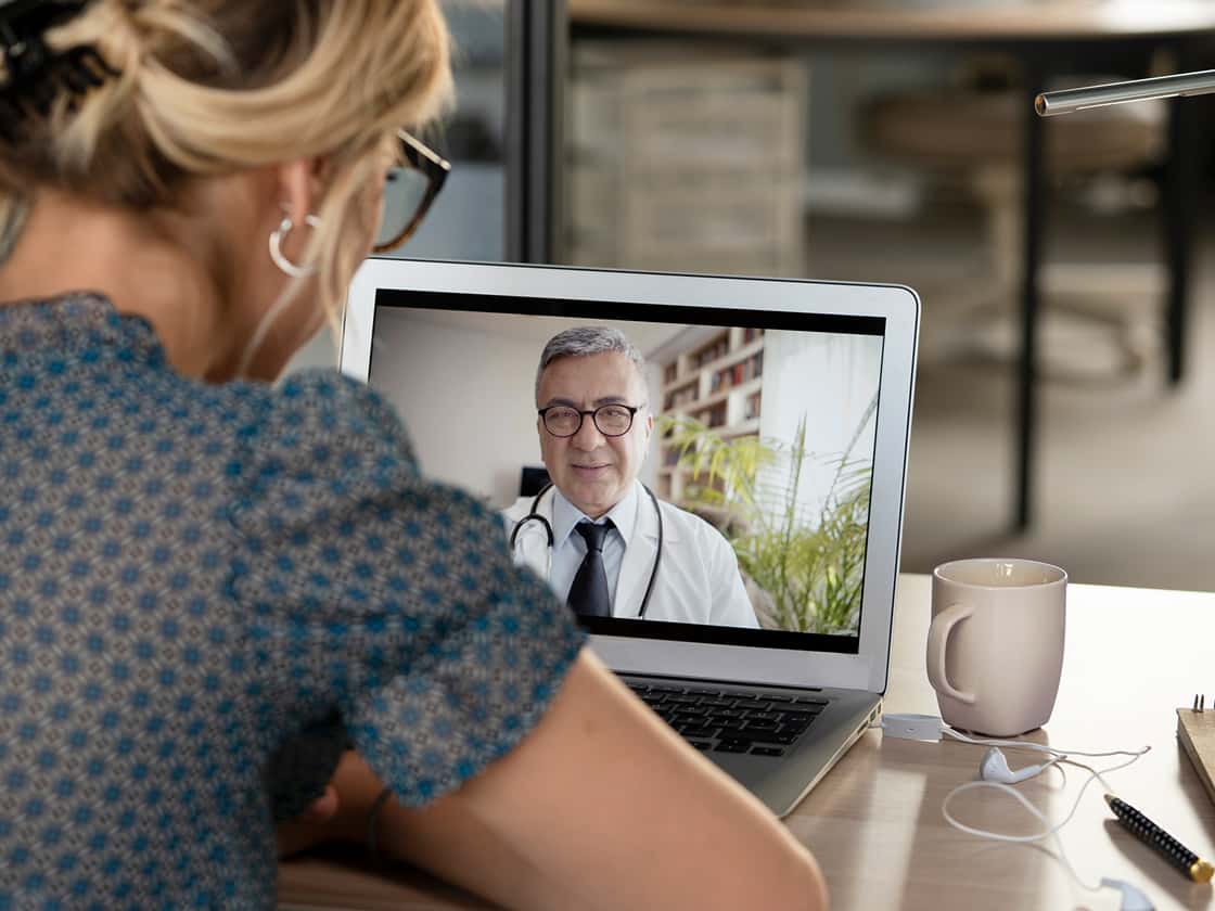 Young woman talking with doctor on digital tablet 