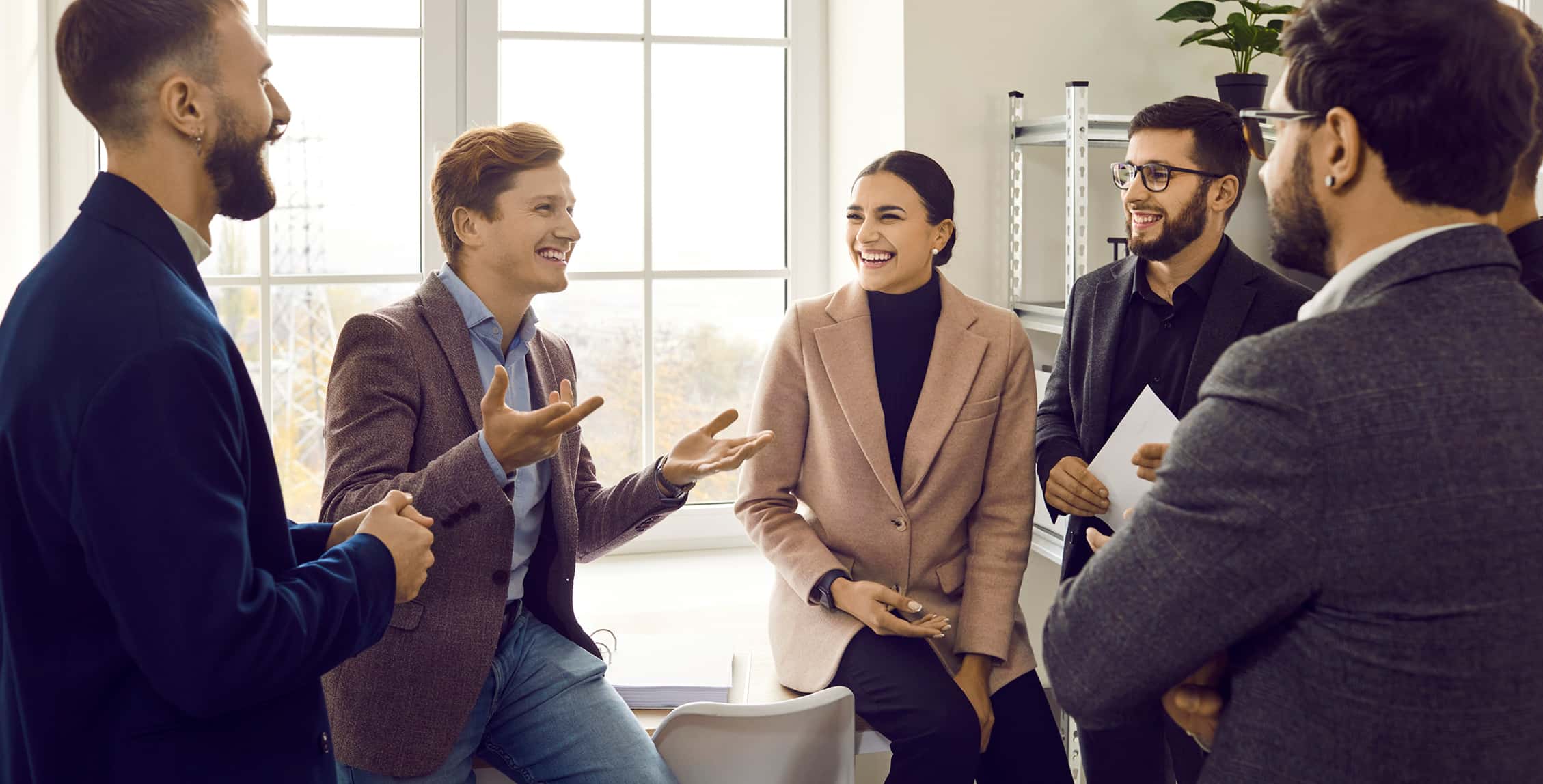 Company employees talking in the office.