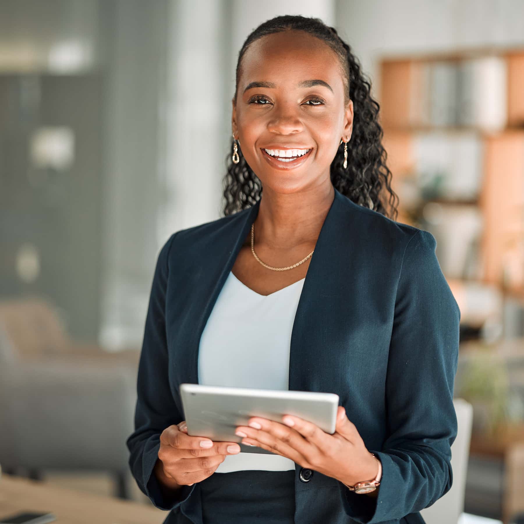 Business woman holding tablet computer smiling facing camera